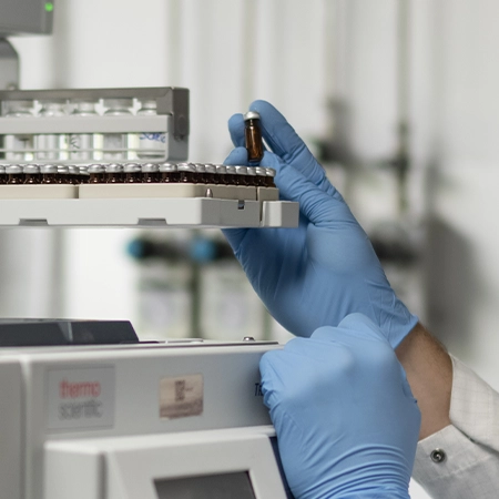 hands of a chemist taking a sample for analysis in the Rivoli laboratory